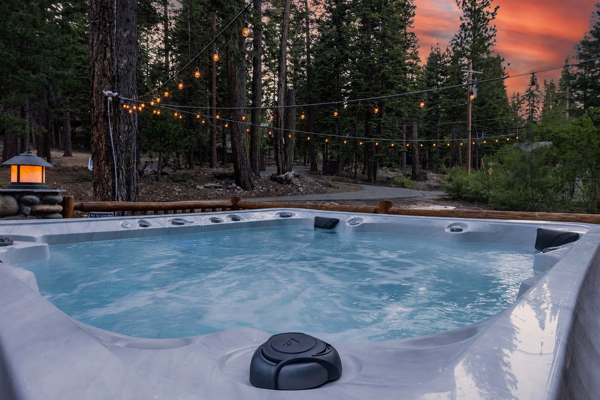 Ease into the hot tub as the string lights flicker on and the sunset burns through the firs — the day melting right off your shoulders.